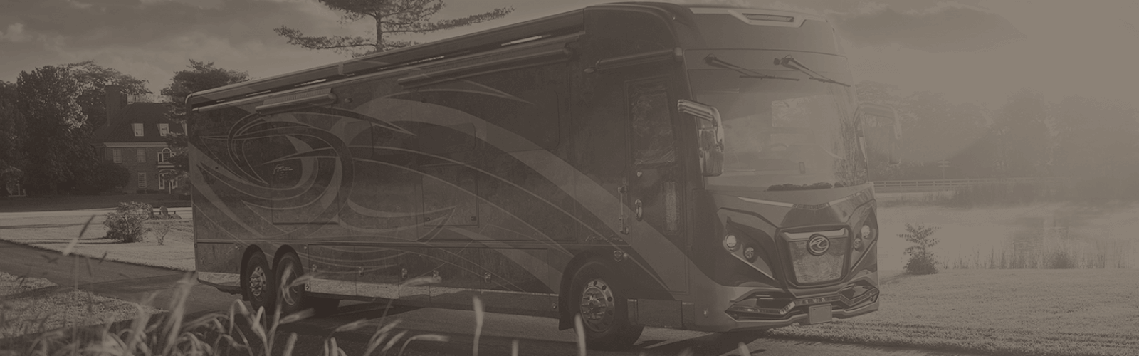 american coach rv on the road next to a scenic view